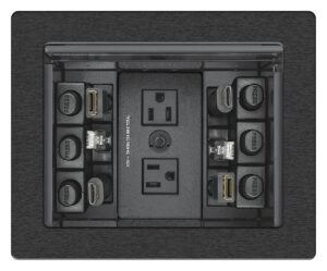 Boîtier de table Extron Cable Cubby 700 installé dans une salle de réunion pour la connectique HDMI, USB-C et RJ45.